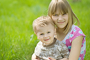 siblings in grass