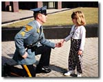 Trooper shaking hands with a little girl