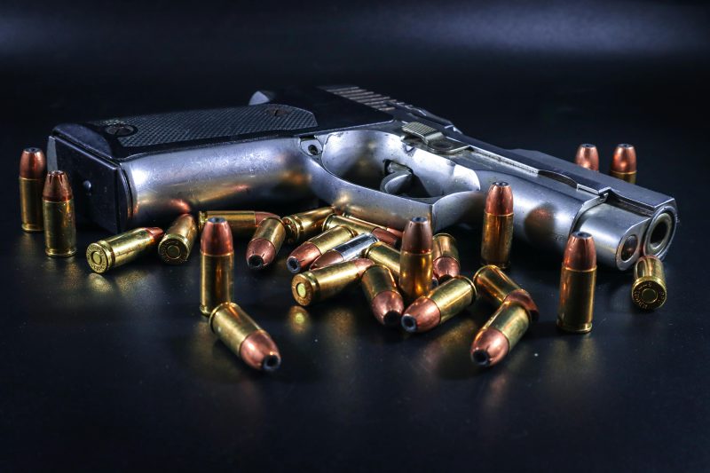 photo of gun with many bullets