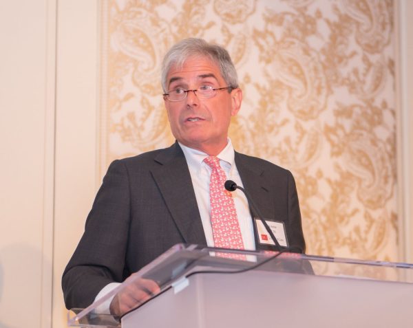 photo of Bruce P. Keller standing behind a podium