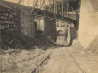 "Entrance to Canal from Delaware River, closed up, showing the abandonment of the Canal." [looking down Plane 11 West, toward the Delaware River; canal arch boarded up; looking northwest]