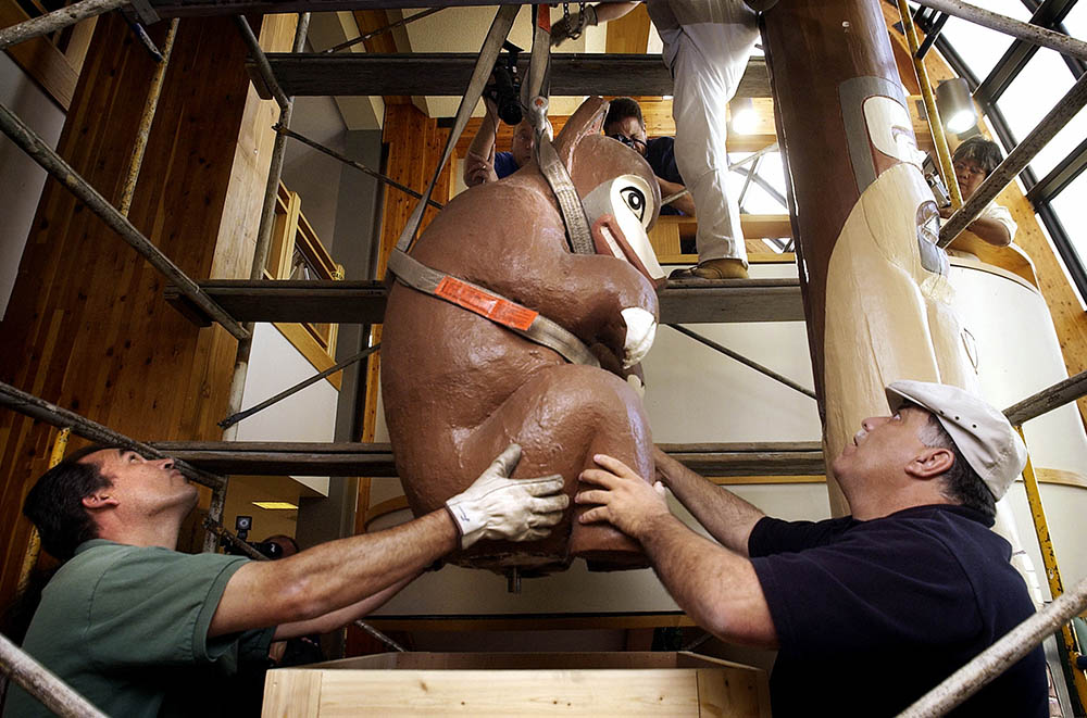 University of Northern Colorado maintenance crew workers guide a 600-pound bear totem pole top into a crate to be shipped back to the Tlingit Nation in Angoon, Alaska, where the totem originally stood and disappeared in 1908. - CreditCreditGlenn Asakawa/The Denver Post, via Getty Images