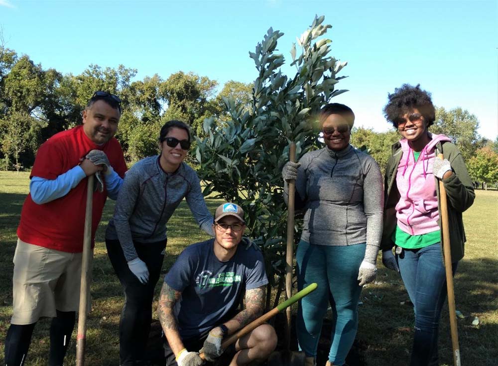 Volunteers take a break after planting a tree at Gateway Park on October 5th