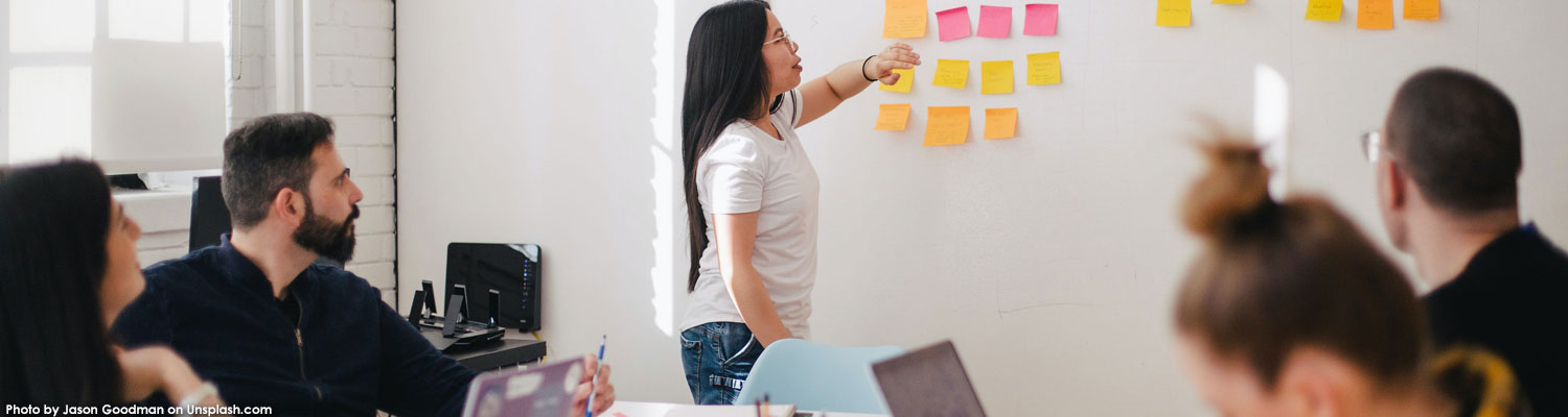 People looking at whiteboard with notes