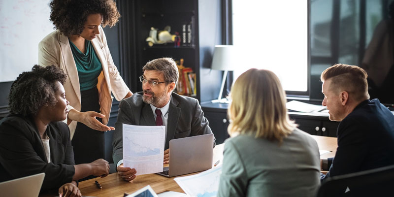 Professionals talking around a table