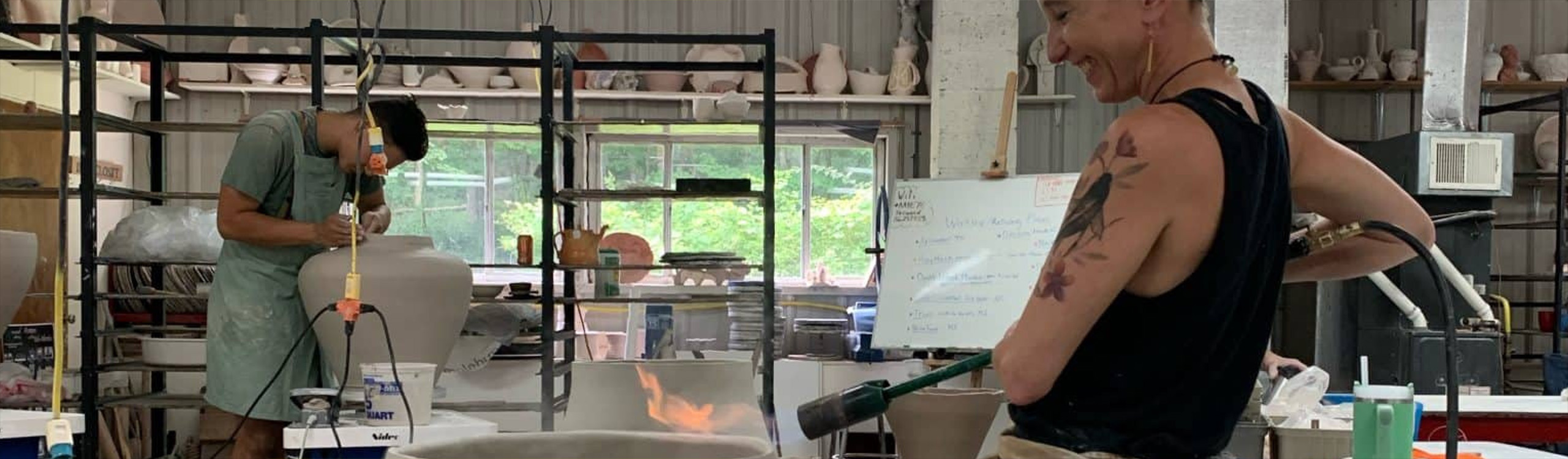 two ceramic artists working in a studio