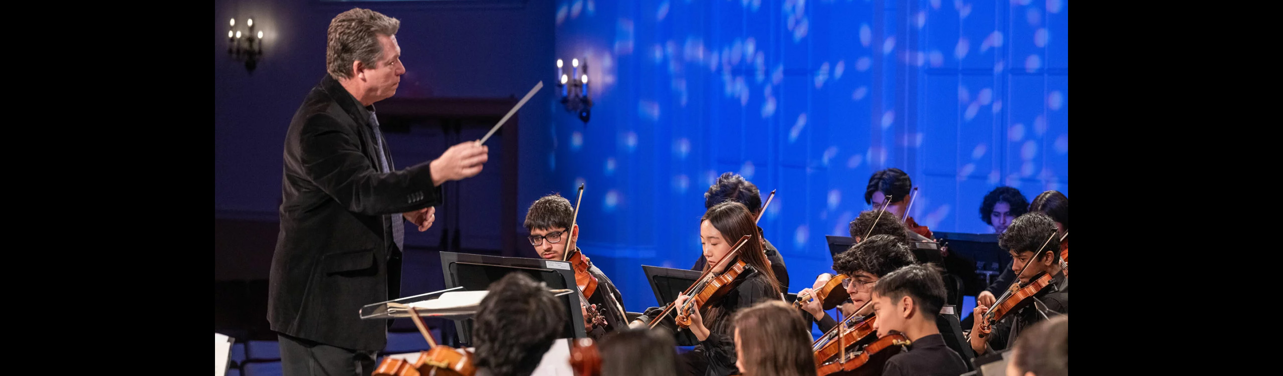 conducter leads youth orchestra