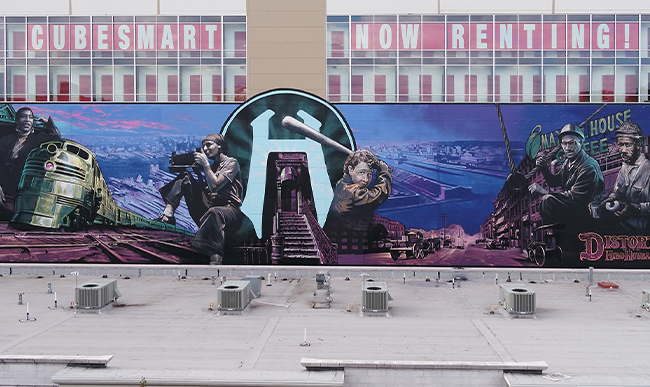 A mural depicting scenes and people from Hoboken.