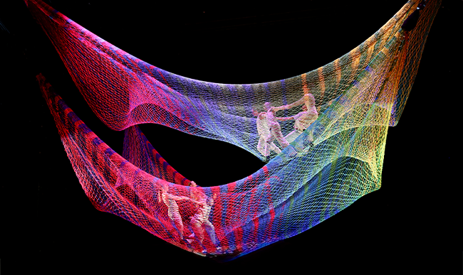 Six aerial dancers performing inside two custom-designed net sculptures.