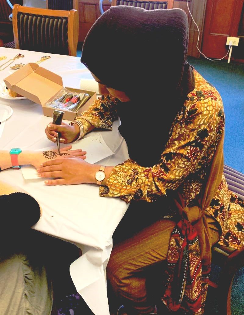 Samira Yeasmin demonstrating Henna art at the grand opening. 