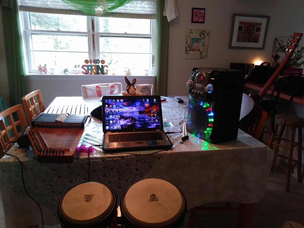 A low-key Homebound music studio equipped with Karaoke machine, guitar, autoharp, and bunny ears, created by Valerie Vaughn. Spring 2020.