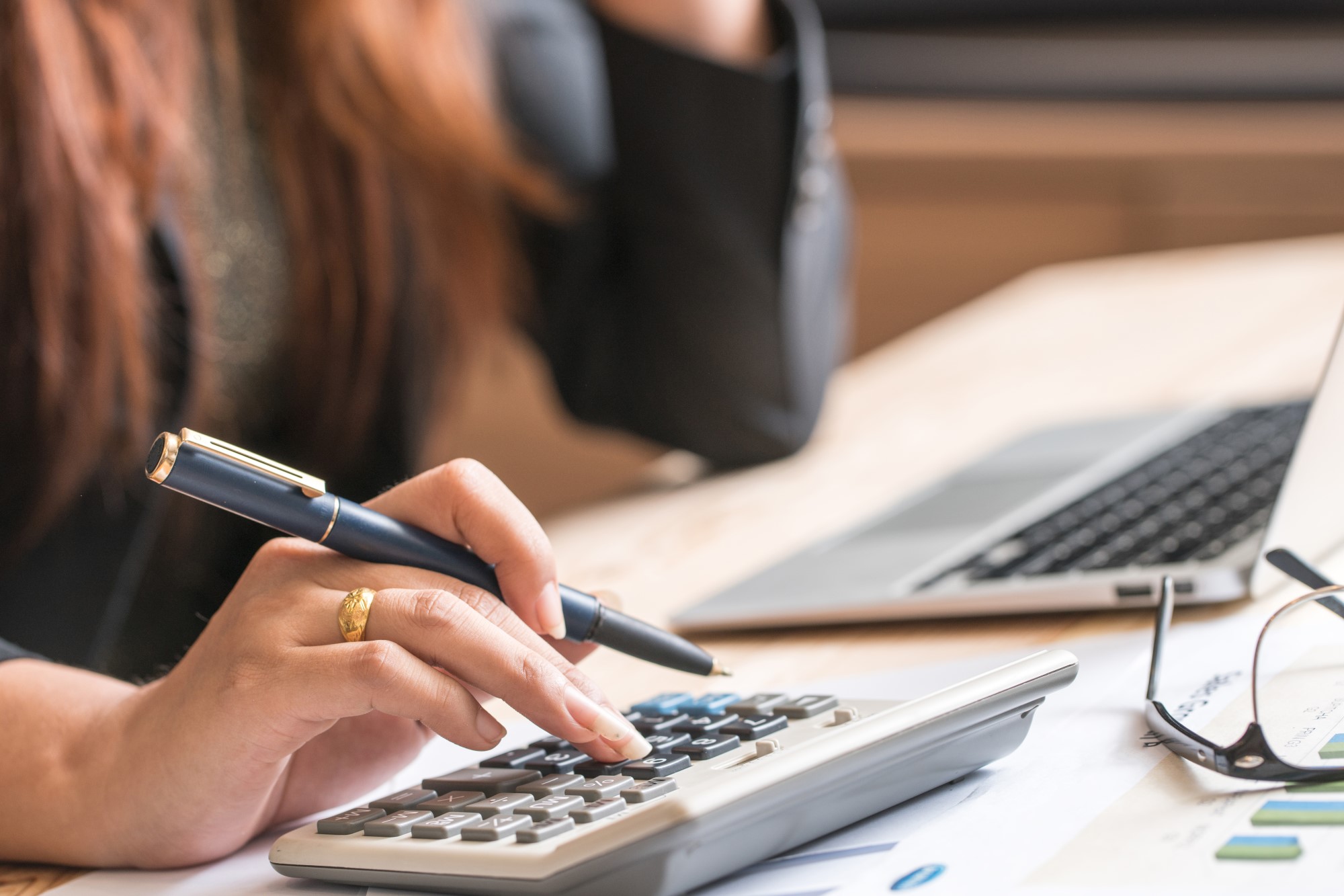 Woman using calculator