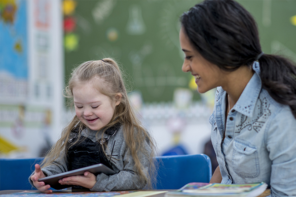 child and teacher in classroom